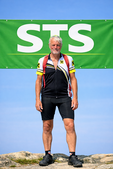 Person mittig mit STS Banner in Maigrün und weißer Schrift